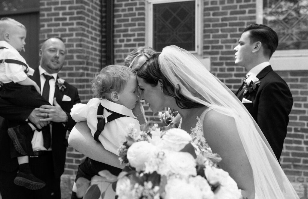 Bride hugging ring bearer after wedding ceremony