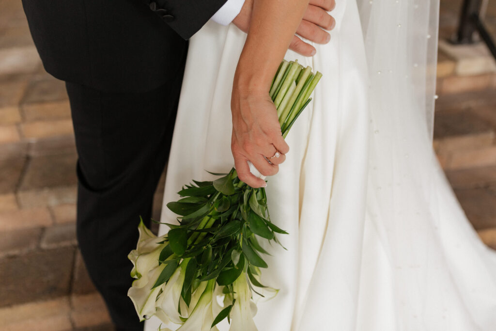 brides hand holding floral bouqet